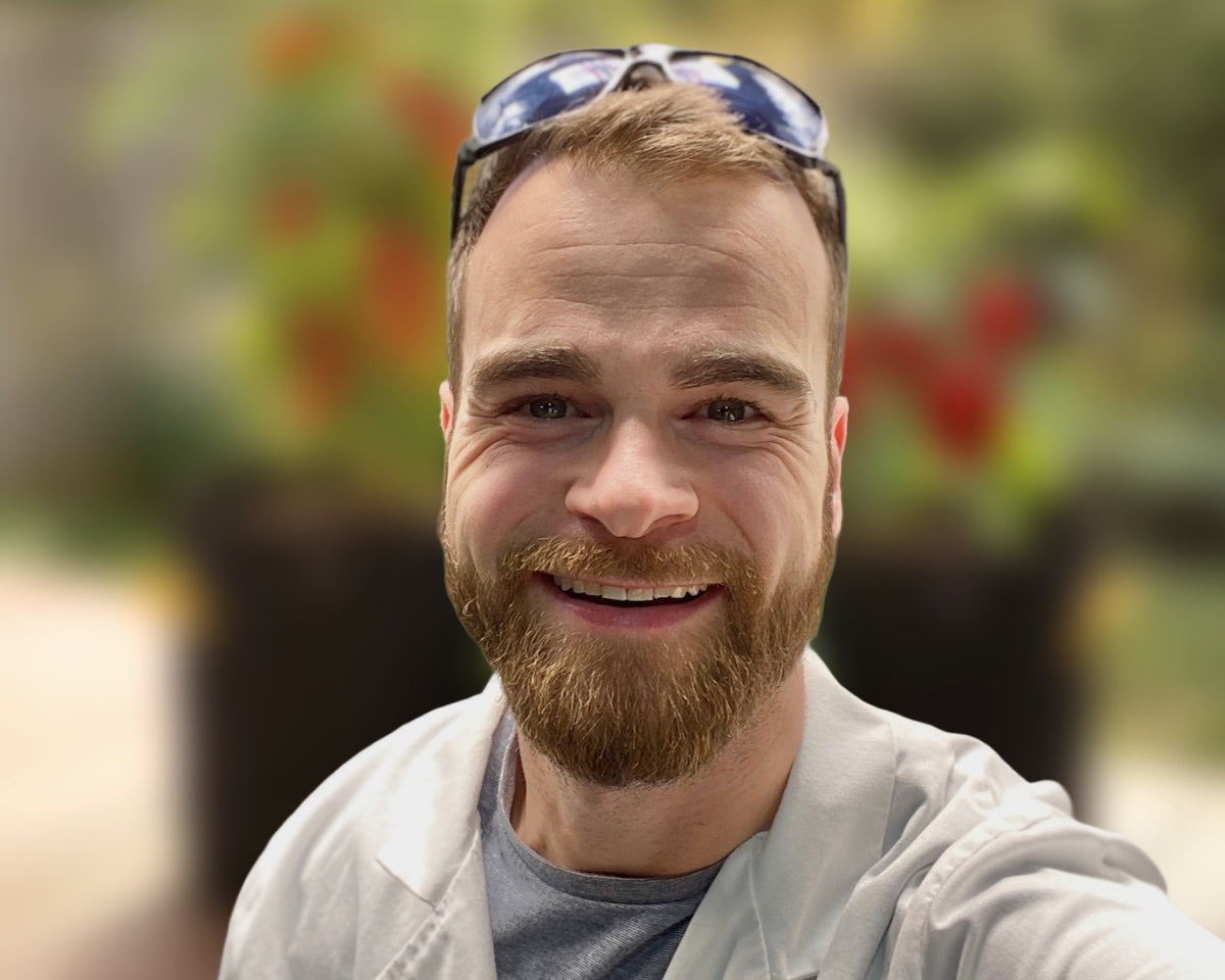 Henrique, founder of Online Garden Co., in a garden