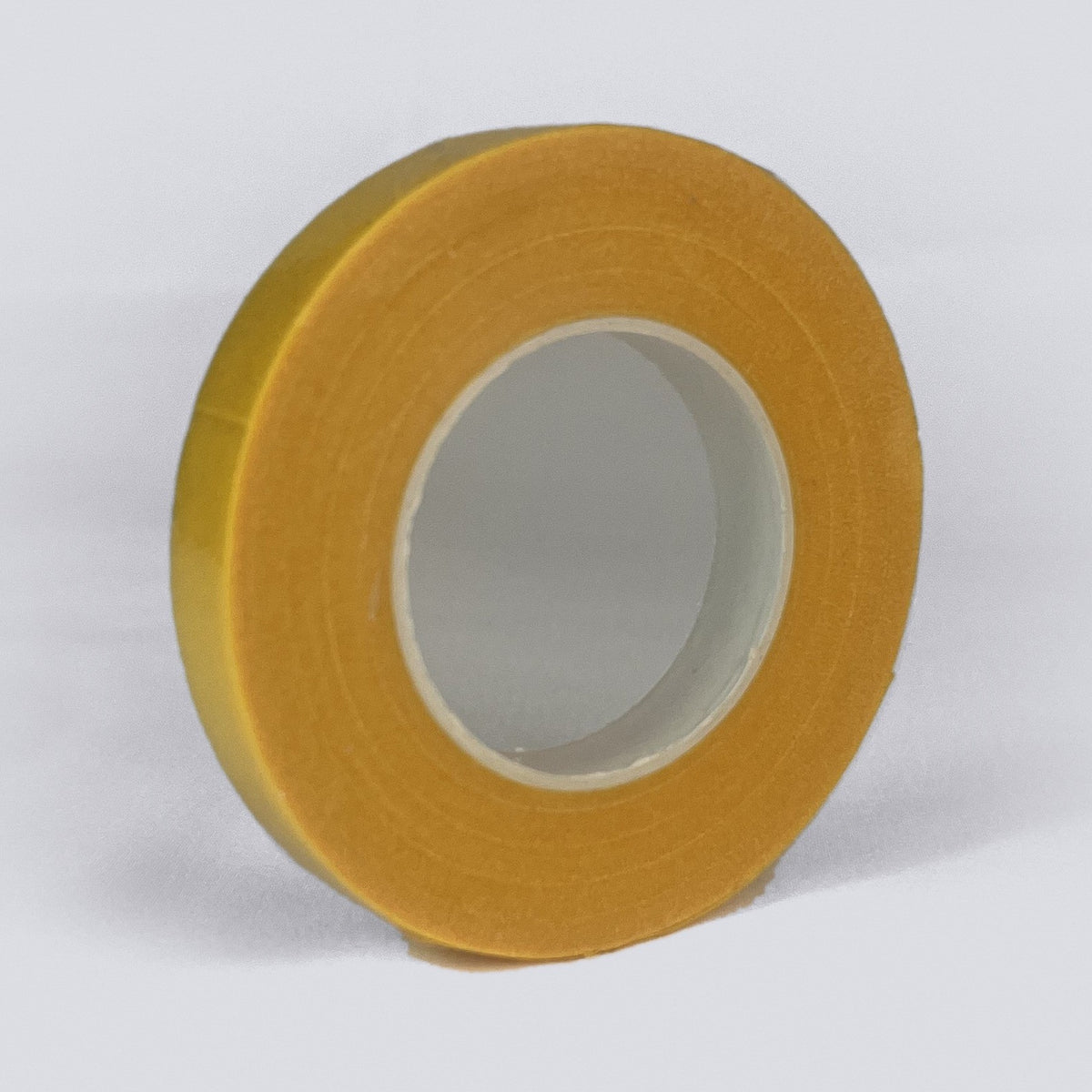 Roll of yellow branch repair and grafting tape on a grey background